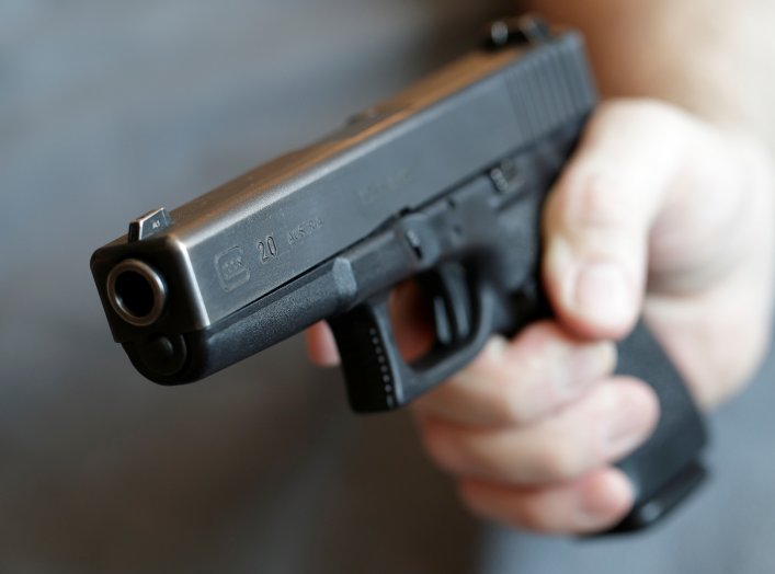 A gun owner displays a Glock 20, 10 mm Auto pistol in Vienna, Austria, March 22, 2018. REUTERS/Heinz-Peter Bader