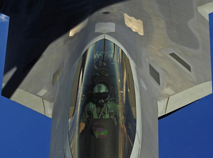 A U.S. Air Force F-22 Raptor pilot assigned to the 90th Fighter Squadron, Elmendorf Air Force Base, Alaska, receives fuel from a KC-135 Stratotanker with the 465 Air Refueling Squadron out of Tinker Air Force Base, Okla