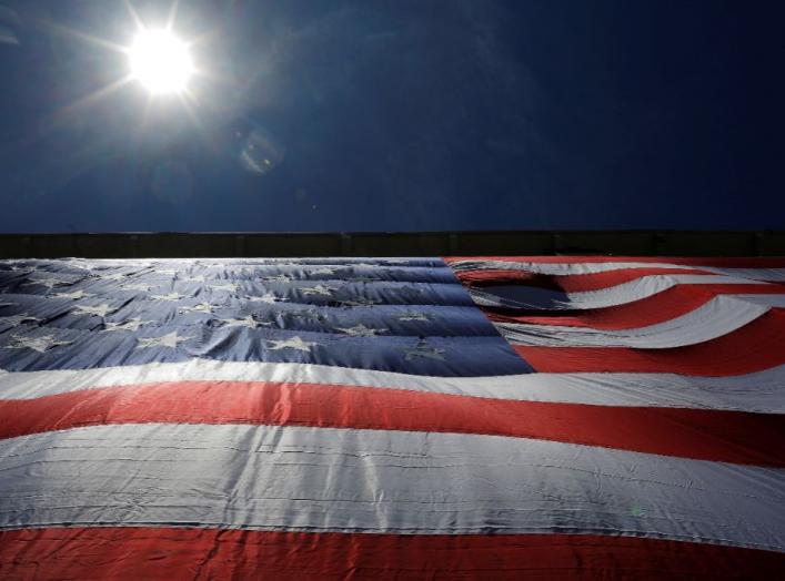 As 95-by-50-foot American flag is unfurled on the side of an apartment complex, a replica of the "The Great Flag" that was spun, woven, dyed, constructed and displayed on the same building by Amoskeag Manufacturing Company in 1914, in Manchester, New Hamp