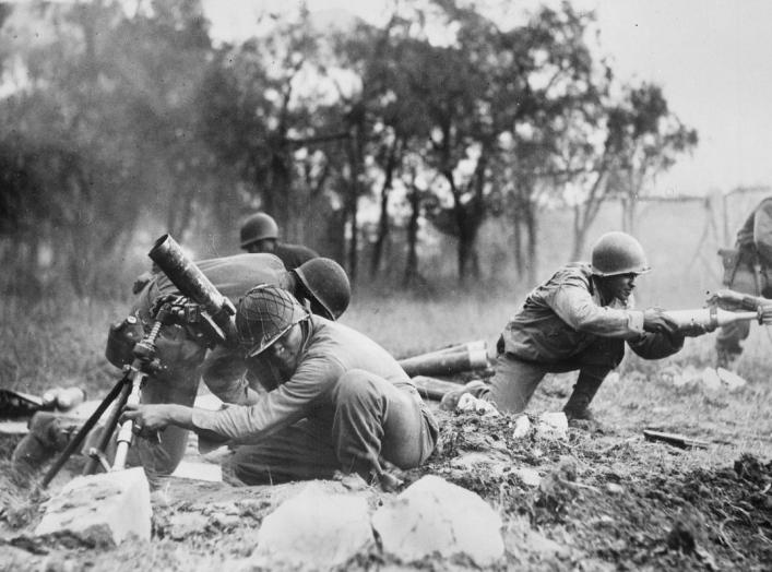 Members of a mortar company of the 92nd Division pass the ammunition and heave it over at the Germans in an almost endless stream near Massa, Italy. This company is credited with liquidating several machine gun nests. Wikimedia Commons