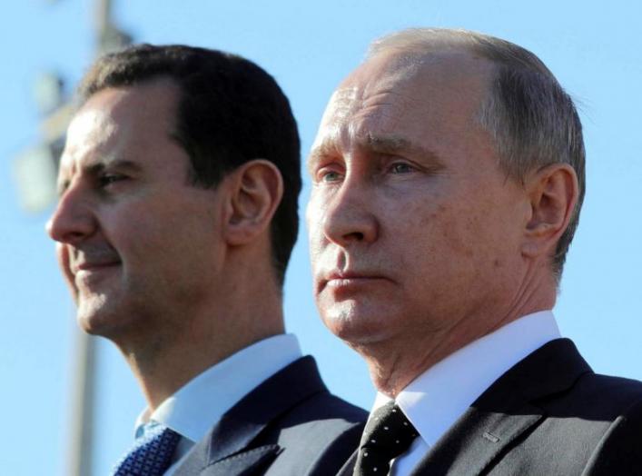 Russian President Vladimir Putin (R) and Syrian President Bashar al-Assad visit the Hmeymim air base in Latakia Province, Syria December 11. REUTERS/File Photo