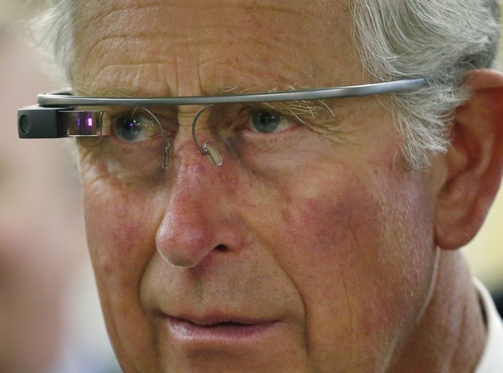 Britain's Prince Charles trys a pair of Google glasses to uses software developed at an innovation center in Winnipeg, Manitoba, May 21, 2014. The royal couple are on a four-day visit to Canada that began in Halifax and includes stops in Pictou, Nova Scot