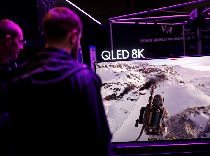 Gamers play on a Samsung QLED 8K television at the Paris Games Week (PGW), a trade fair for video games in Paris, France, October 25, 2018. REUTERS/Benoit Tessier