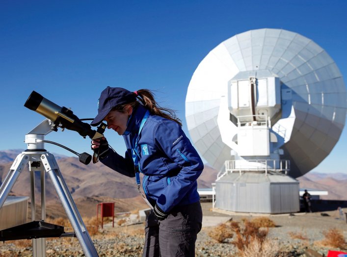 A scientist looks at the sun through a telescope before of the solar eclipse in La Silla European Southern Observatory (ESO) at Coquimbo, Chile July 2, 2019. REUTERS/Rodrigo Garrido