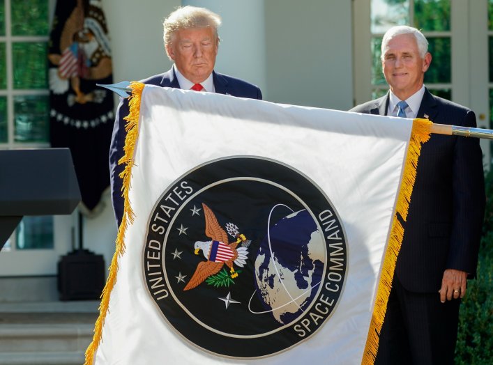 U.S. President Donald Trump stands behind a U.S. Space Command flag with Vice President Mike Pence at an event to officially launch the United States Space Command in the Rose Garden of the White House in Washington, U.S., August 29, 2019. REUTERS/Kevin L