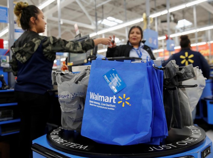 A customer pays for her groceries after shopping at a Walmart store ahead of the Thanksgiving holiday in Chicago, Illinois, U.S. November 27, 2019. REUTERS/Kamil Krzaczynski