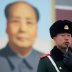 A paramilitary police officer stands guard in Tiananmen Square after a flag raising ceremony in front of a portrait of the late Chinese Chairman Mao Zedong ahead of the upcoming plenary session of National People's Congress (NPC), China's parliamentary bo