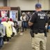 Homeland Security Investigations (HSI) officers from Immigration and Customs Enforcement (ICE) look on after executing search warrants and making some arrests at an agricultural processing facility in Canton, Mississippi, U.S. in this August 7, 2019 hando