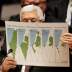 Palestinian President Mahmoud Abbas holds a document while speaking during a Security Council meeting at the United Nations in New York, U.S., February 11, 2020. REUTERS/Shannon Stapleton