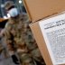 A U.S. Army National Guard soldier wears a protective face mask while loading a vehicle with food for delivery to residents in need at the Kingsbridge Armory which is being used as a temporary food distribution center during the outbreak of the coronaviru