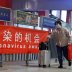 People wearing protective face masks walks by a regional bus station in Beijing as the spread of the coronavirus disease (COVID-19) continues in Beijing, China April 30, 2020. REUTERS/Thomas Peter