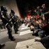 Protesters sit in the street facing a line of riot policemen during nationwide unrest following the death in Minneapolis police custody of George Floyd, in Raleigh, North Carolina, U.S. May 31, 2020. REUTERS/Jonathan Drake