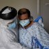 Fernando Olvera, 26, a medical school student, helps Efrain Guevara, 63, who has been hospitalised with COVID-19, get up from his hospital bed, at United Memorial Medical Center (UMMC), during the coronavirus disease (COVID-19) outbreak, in Houston, Texas