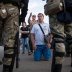 People talk to Belarusian law enforcement officers near the site where a protester died on August 10 during a rally following the presidential election in Minsk, Belarus August 11, 2020. REUTERS/Stringer