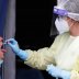 A healthcare worker takes a swab sample from a man at a coronavirus disease (COVID-19) test centre at Rome's San Giovanni hospital in Rome, Italy, August 18, 2020. REUTERS/Remo Casilli