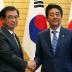 Japan's Prime Minister Shinzo Abe shakes hands with South Korea's National Intelligence Service chief Suh Hoon before their meeting at Abe's official residence in Tokyo, Japan September 10, 2018. Koji Sasahara/Pool via Reuters