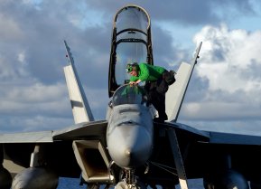 PACIFIC OCEAN (May 30, 2011) A Sailor steps into the cockpit of an F/A-18F Super Hornet assigned to Strike Fighter Squadron (VFA) 22 aboard the Nimitz-class aircraft carrier USS Carl Vinson (CVN 70). 